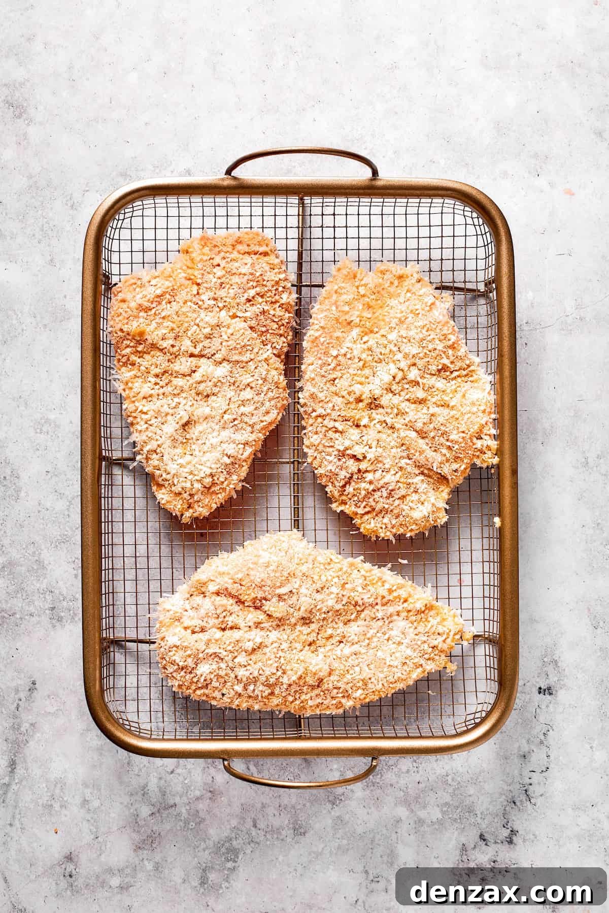 This Cheesecake Factory copycat crusted chicken romano stars crispy, breaded chicken cutlets served on pasta with marinara. Three pieces of breaded chicken for crusted chicken romano.