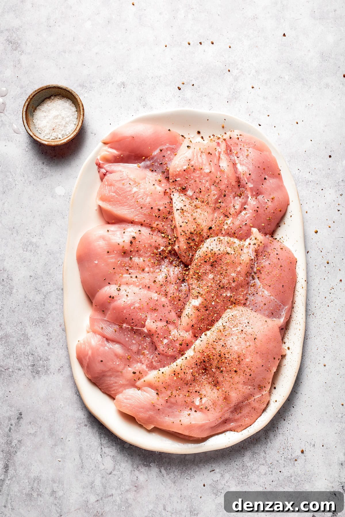 This Cheesecake Factory copycat crusted chicken romano stars crispy, breaded chicken cutlets served on pasta with marinara. Chicken breasts after being pounded and seasoned.
