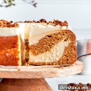 A slice is removed from a platter of carrot cake cheesecake.