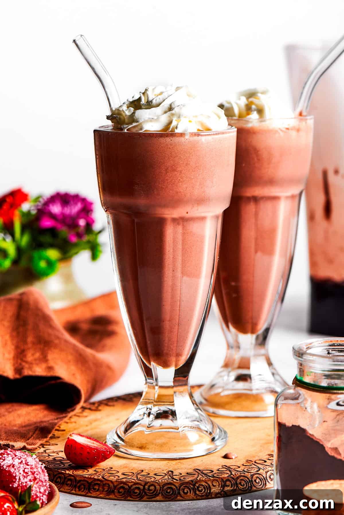 Chocolate milkshakes topped with whipped cream.