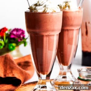 Chocolate milkshakes topped with whipped cream.