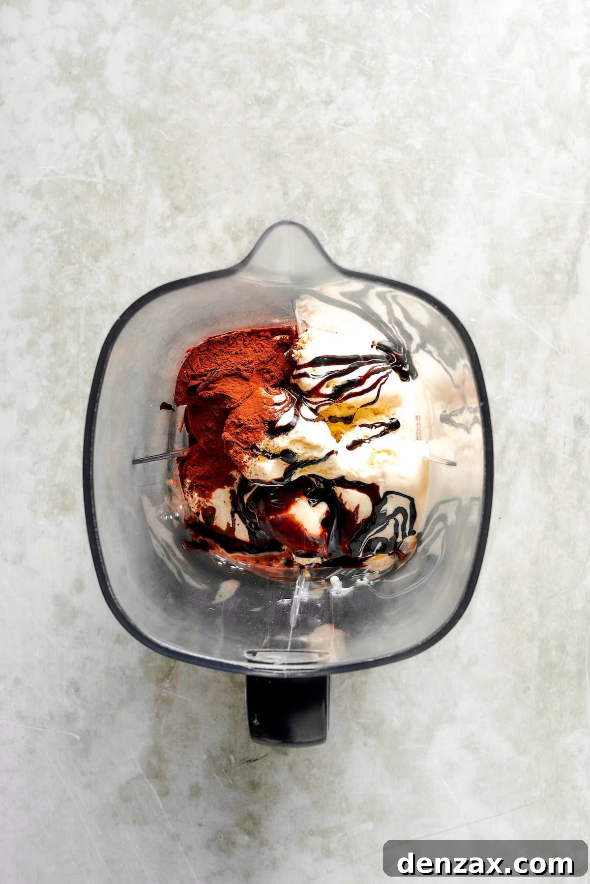 Ingredients for chocolate milkshakes are added to a blender.
