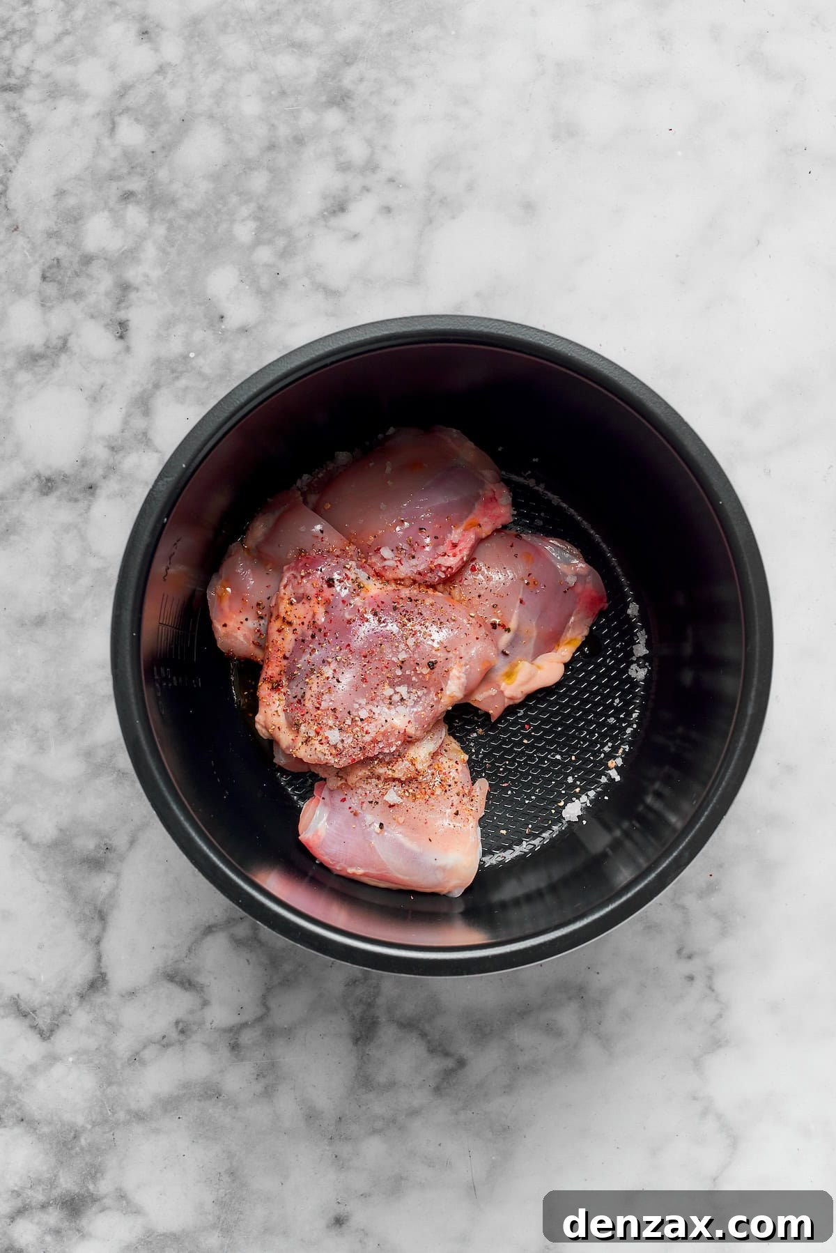 Chicken thighs cook in a pot.