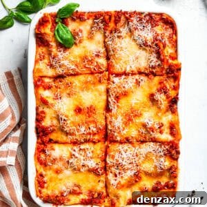 A pan of beef lasagna cut into squares.