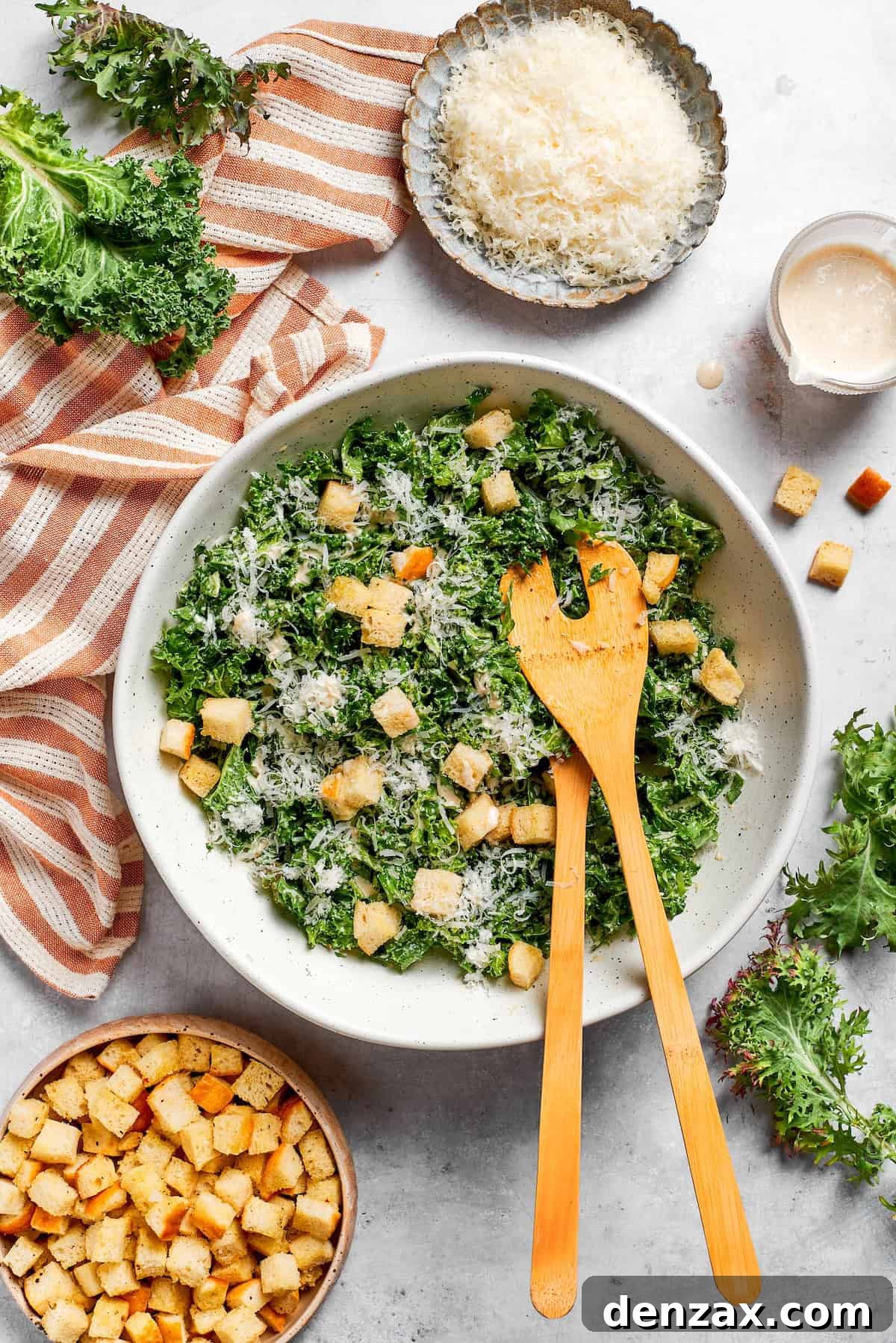 Bowls of cheese and croutons next to a bowl of kale salad Bowls of cheese and croutons next to a bowl of kale salad.