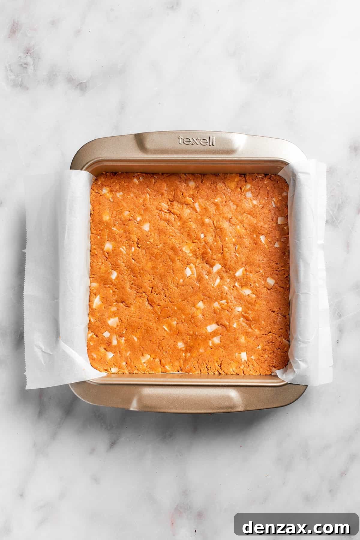 Graham cracker crust is pressed in a pan.