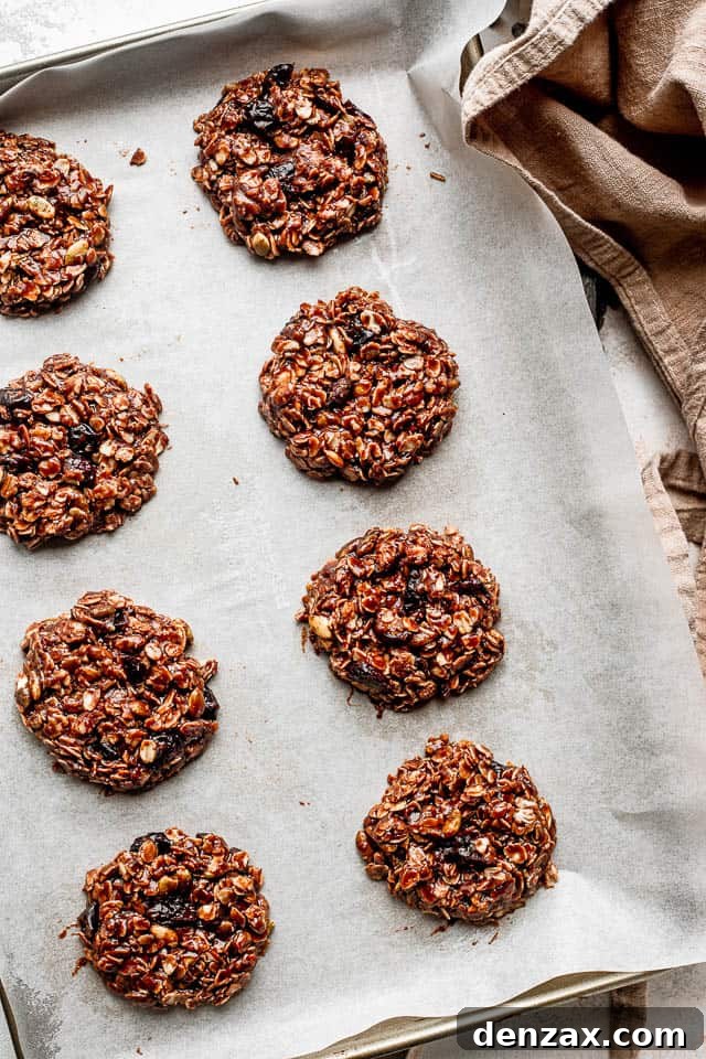 top view of oatmeal cookies set on parchment paper covered baking sheet