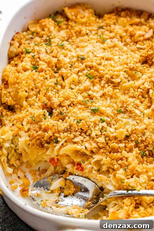 top side shot of a serving spoon inside a baking dish with tuna noodle casserole