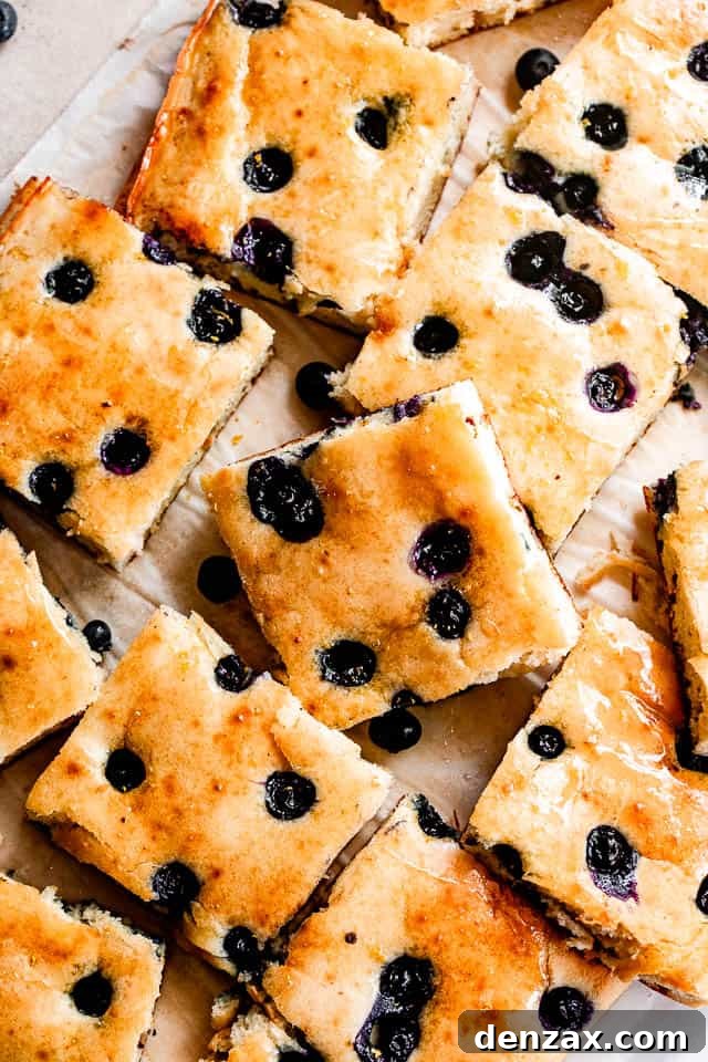 Sheet-Pan Pancakes Recipe: Fluffy Oven-Baked Pancake Tray 4 sheet pan pancakes topped with blueberries and cut into squares