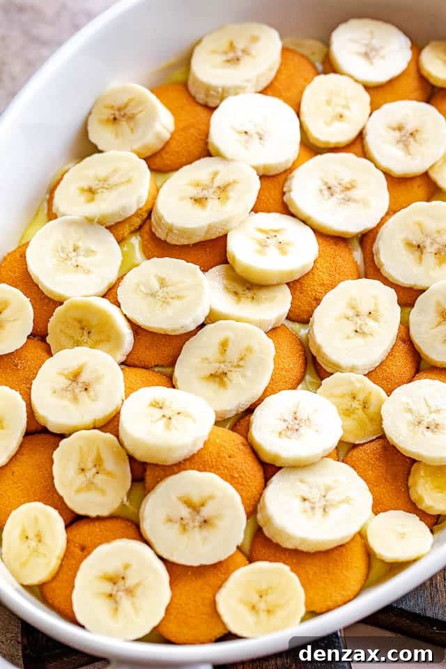 layered vanilla wafers and banana slices in a white baking dish