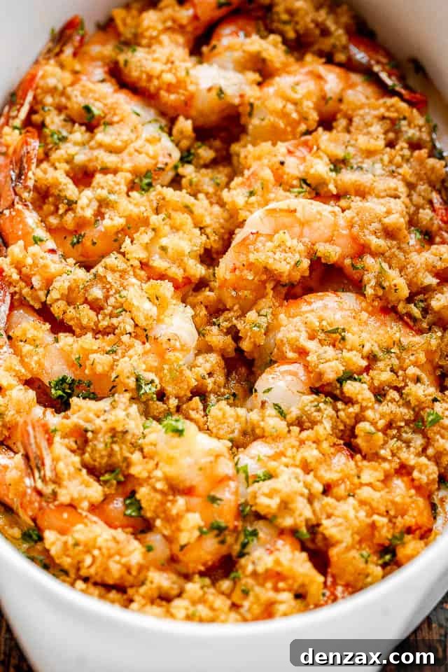 Baked shrimp in a white oval dish.