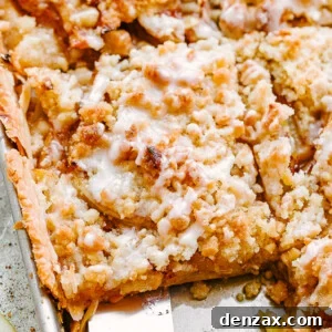 top shot of a spatula removing apple pie from a sheet pan.