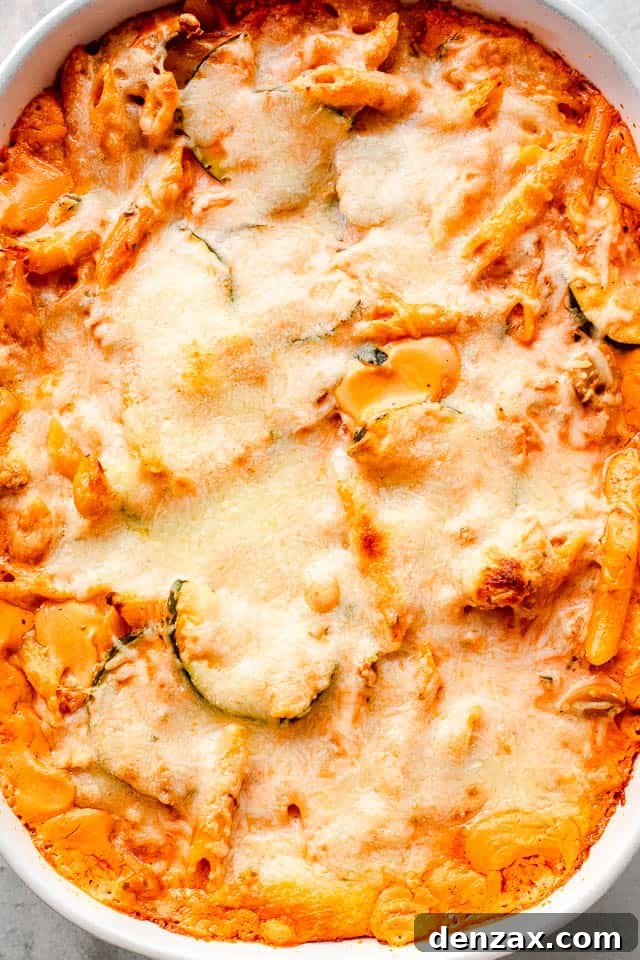 Creamy Baked Pasta with Zucchini and Mushrooms Recipe 6 top overhead shot of a cheesy covered baked pasta and zucchini casserole