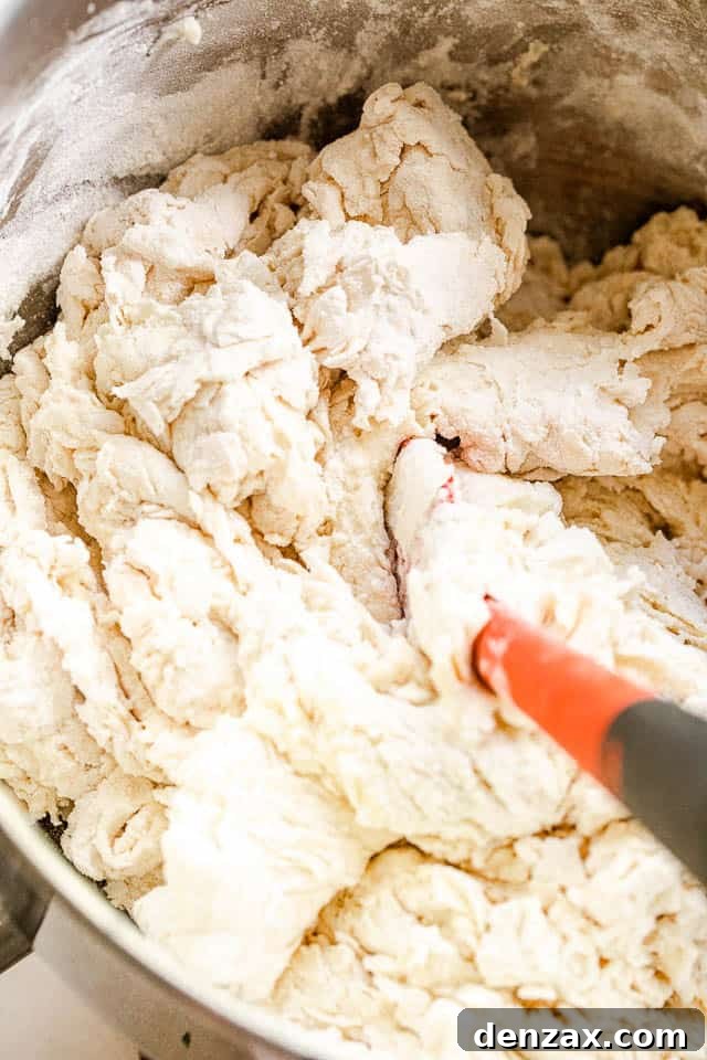 mixing bread dough with a red rubber spatula