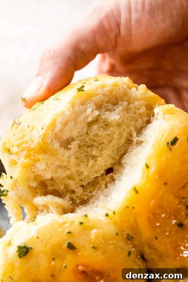 side shot of pulling apart dinner rolls