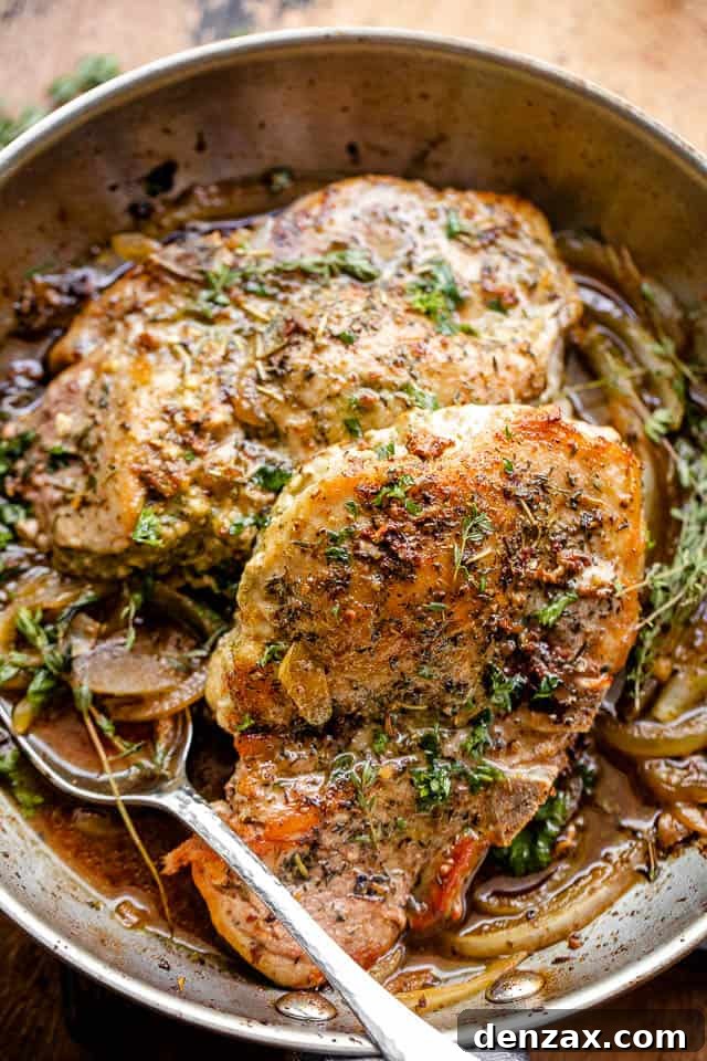 overhead close-up shot of pesto stuffed pork chops in a skillet