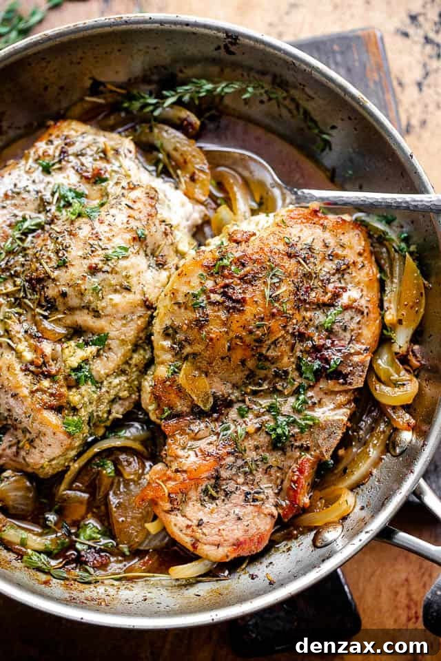 overhead shot of pesto stuffed pork chops in a skillet