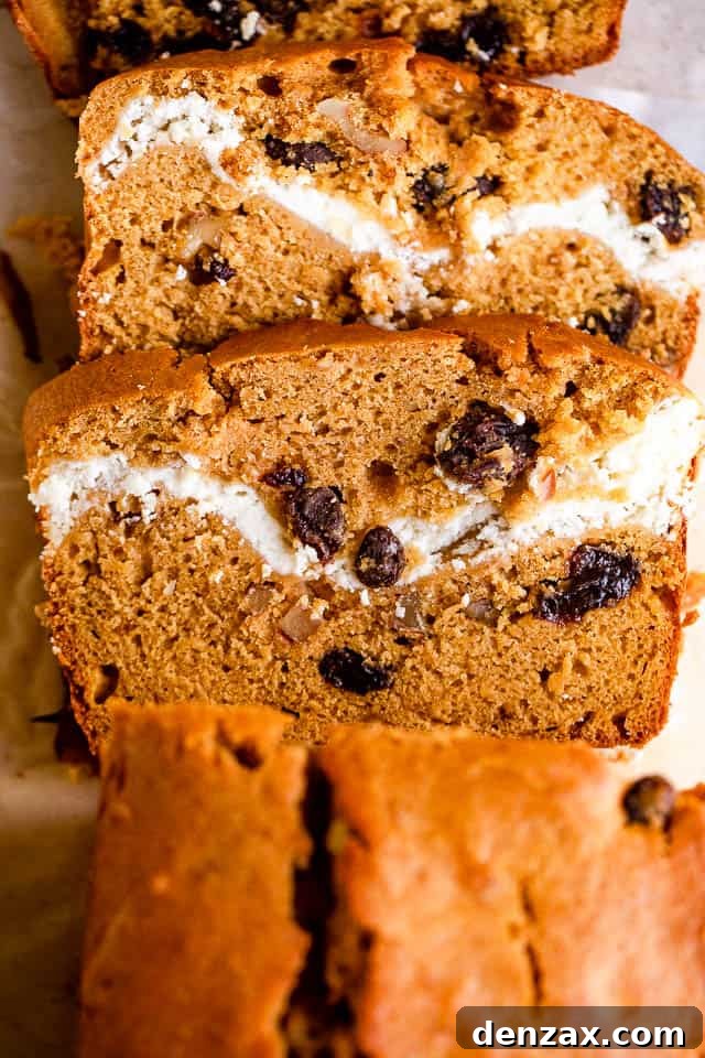 overhead shot of pumpkin bread with a swirl of cream cheese and raisins