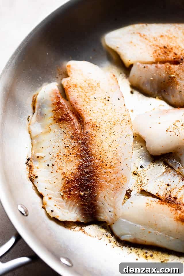 cooking tilapia fillets in a skillet