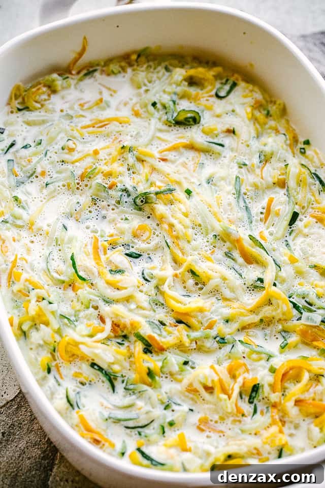 overhead shot of prepped casserole with spiralized zucchini and squash