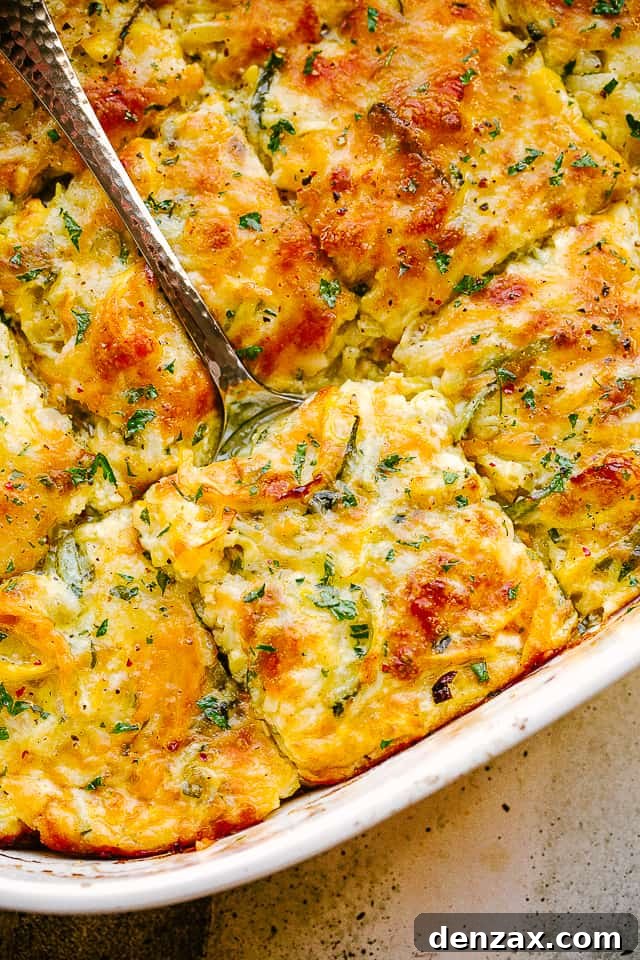scooping out zucchini squash casserole from baking dish