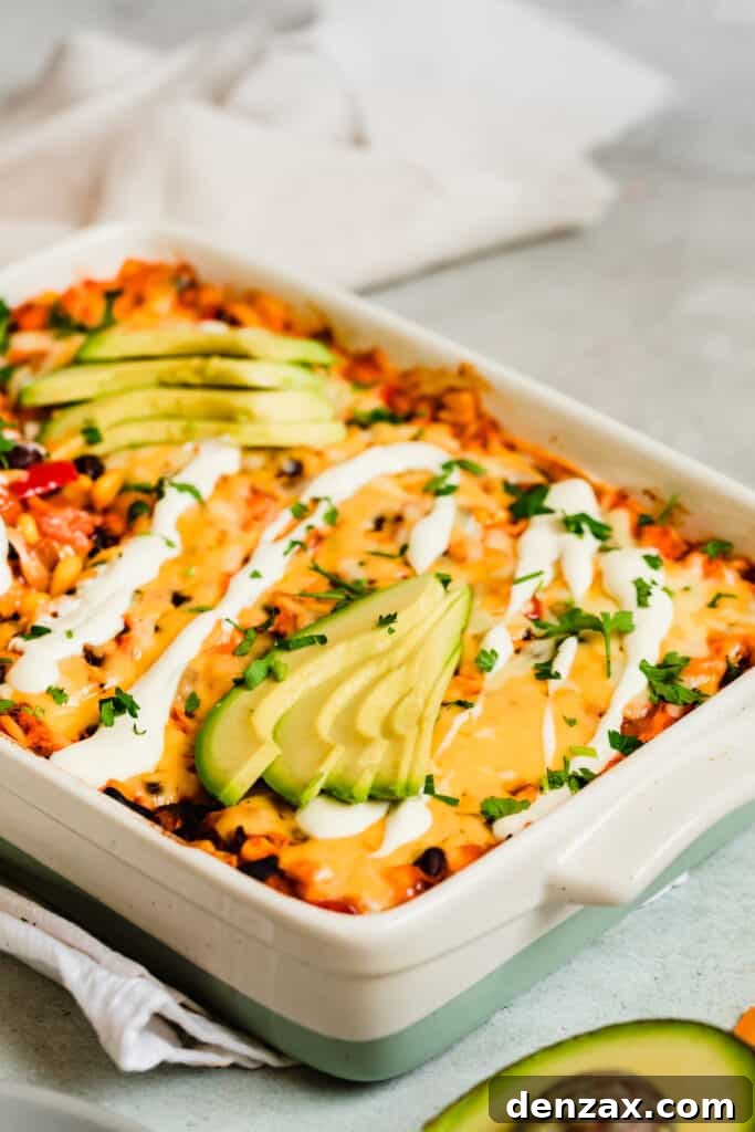 An Enchilada Casserole Topped with Sour Cream and Avocados