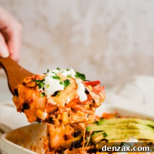 A Serving of Chicken Enchilada Casserole on a Large Wooden Scoop
