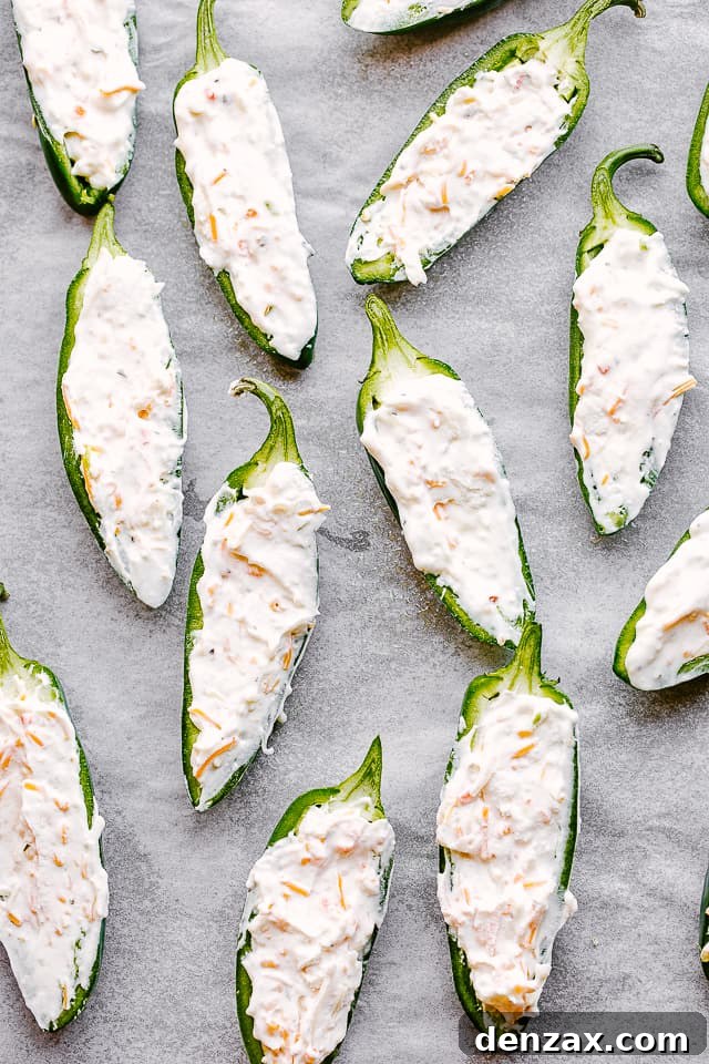 Raw jalapeno halves, stuffed with creamy shredded cheese filling.