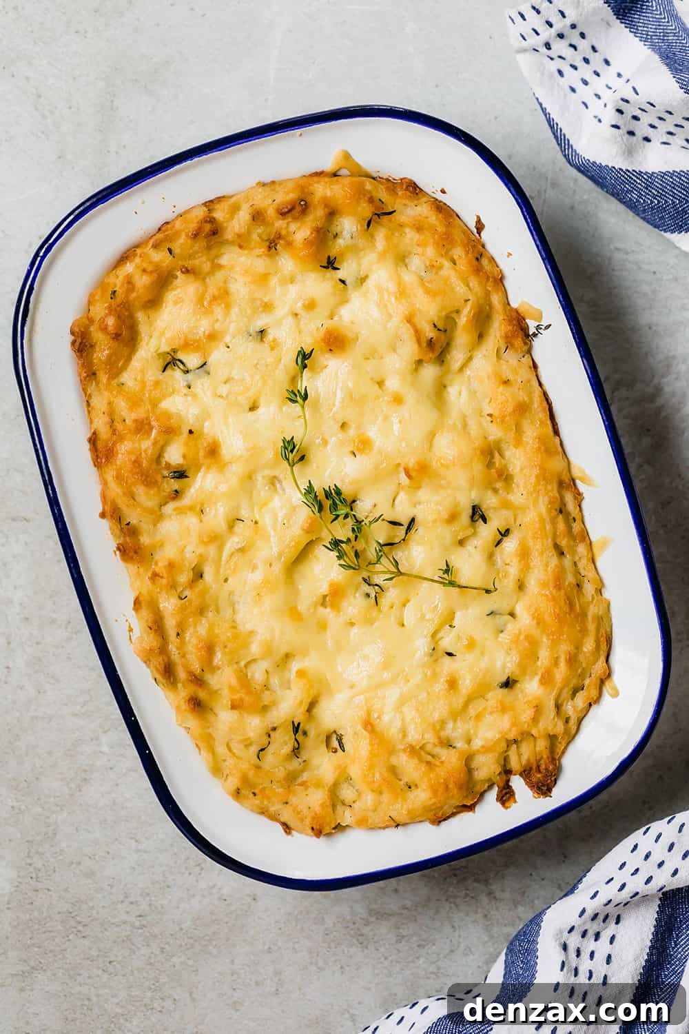 Baked mashed potatoes in a casserole dish.