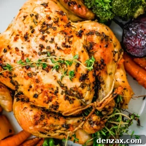 overhead close up shot of whole roast chicken served on a platter.