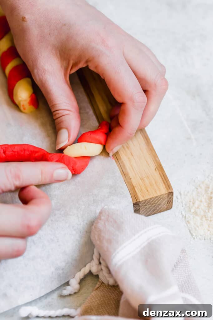 Red and White Cookie Dough Being Twisted Together