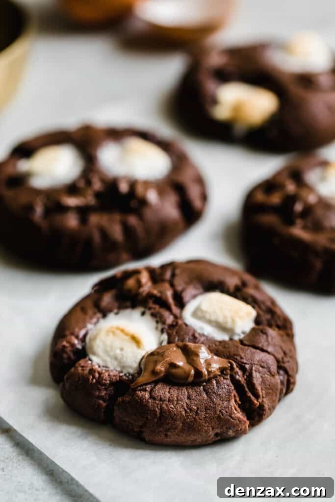 Four Chocolate Marshmallow Cookies on a Sheet of Parchment