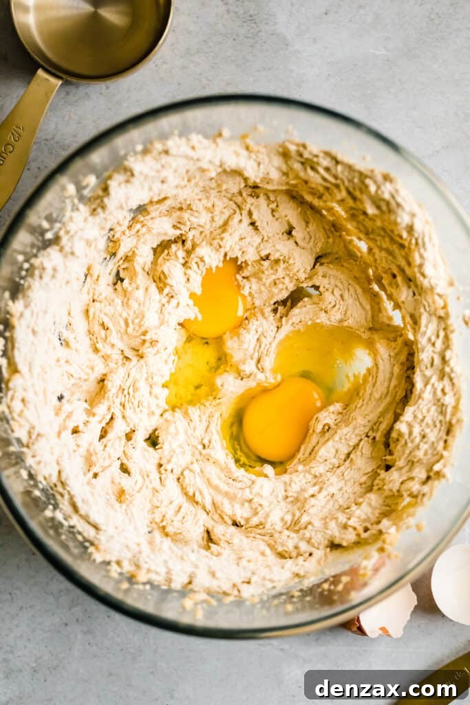 Cookie Batter and Eggs in a Glass Mixing Bowl