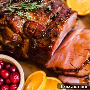 Slices of Christmas Ham on a Circular Wooden Surface with Assorted Fruits