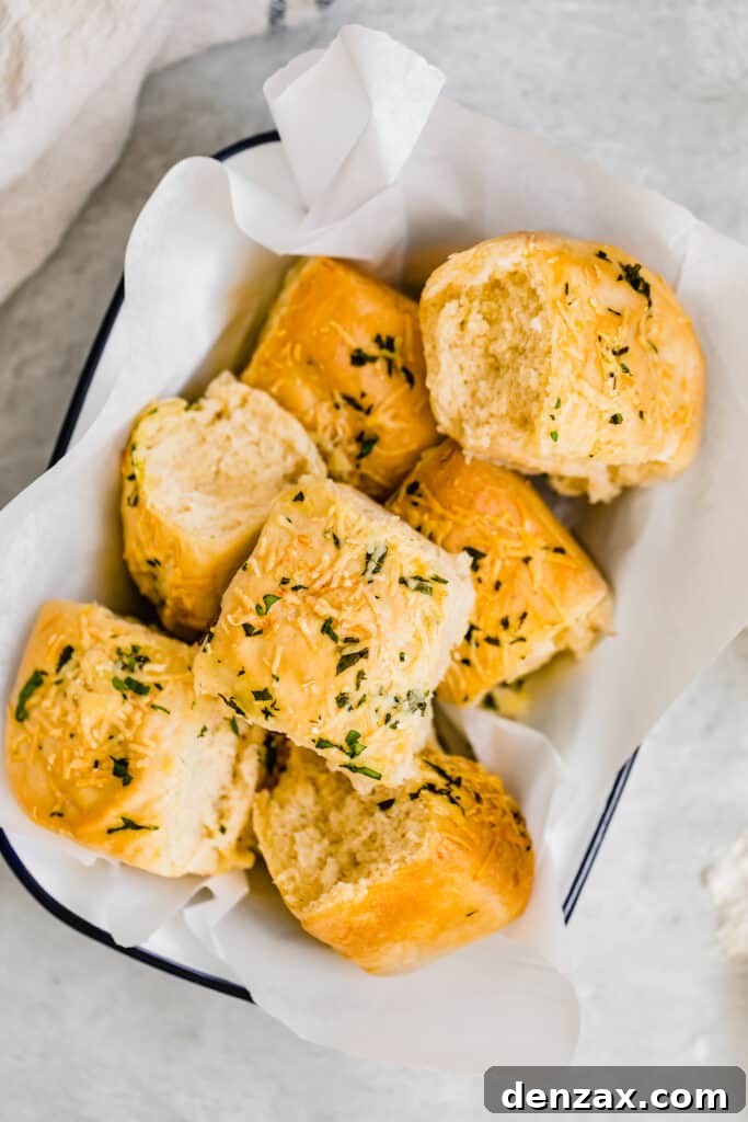 Seven Soft Parmesan Dinner Rolls in a Basket Lined with Tissue Paper