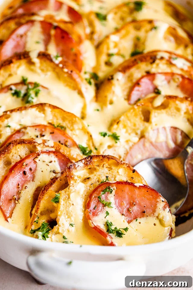 Make-Ahead Eggs Benedict Casserole for Brunch Crowd 2 spooning out eggs benedict casserole from a casserole dish