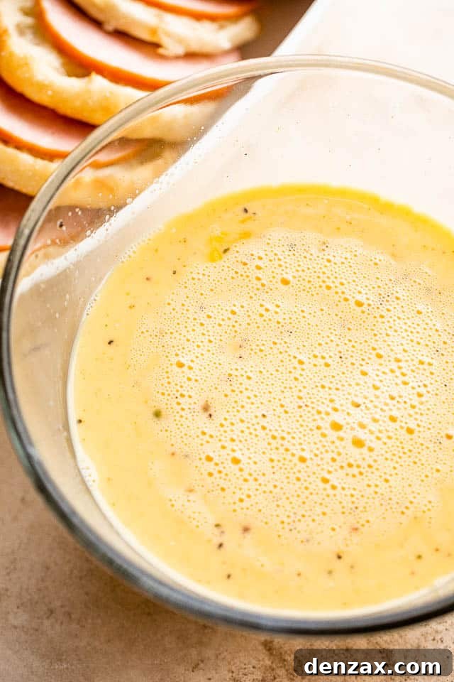 Make-Ahead Eggs Benedict Casserole for Brunch Crowd 4 eggs and milk mixture in a large glass bowl
