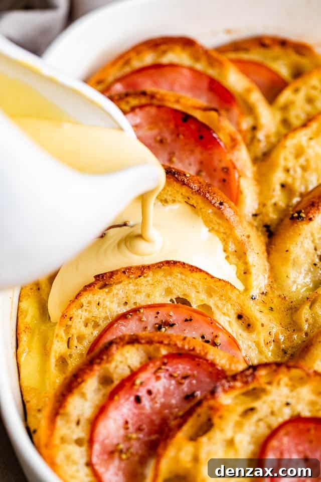 Make-Ahead Eggs Benedict Casserole for Brunch Crowd 6 pouring hollandaise sauce over eggs benedict casserole