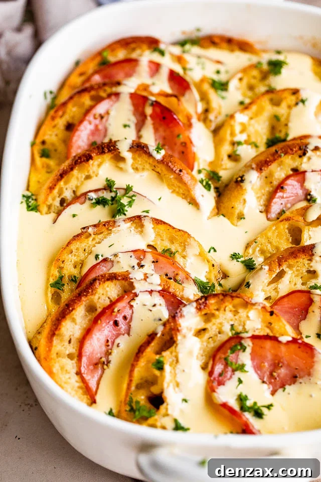Make-Ahead Eggs Benedict Casserole for Brunch Crowd 7 overhead shot of baked eggs benedict casserole topped with hollandaise sauce.