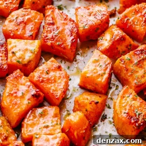 overhead shot of chopped sweet potatoes on parchment paper