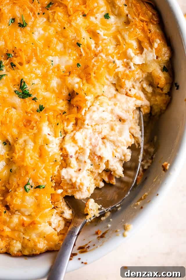 close up shot of a spoon in a baking dish with hot crab dip