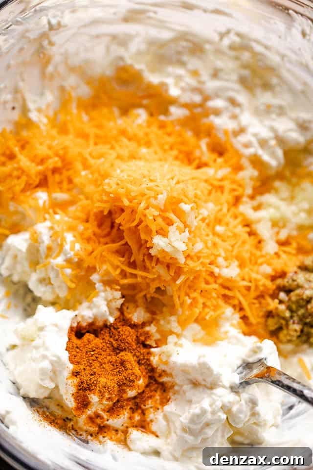 cream cheese, seasonings, and shredded cheese in a mixing bowl