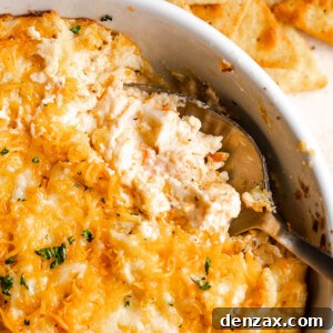 close up shot of a spoon in a baking dish with hot crab dip