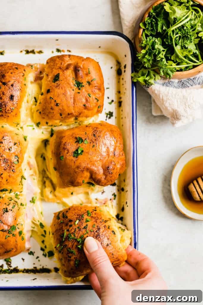 Ham and Swiss Sliders with Honey-Mustard Glaze 7 Six Cheesy Ham Sandwiches in a Navy Blue and White Baking Dish
