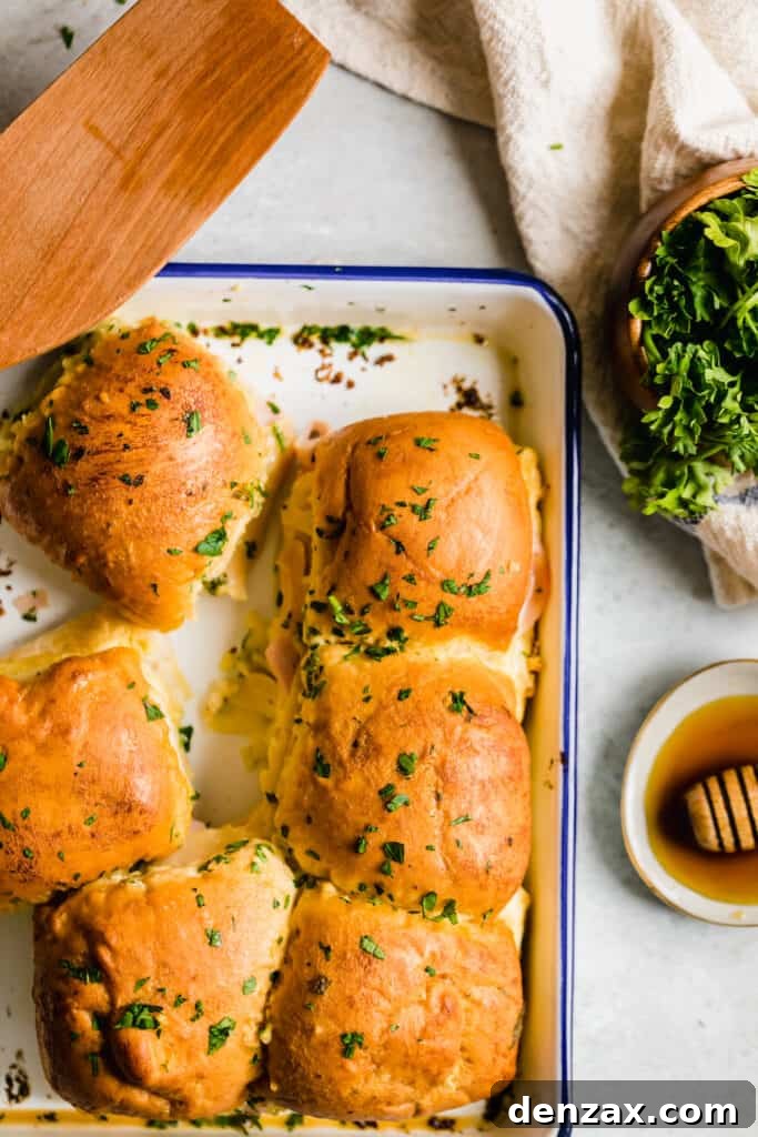 Ham and Swiss Sliders with Honey-Mustard Glaze 8 Six Hot Ham and Cheese Sliders Beside a Bowl of Parsley