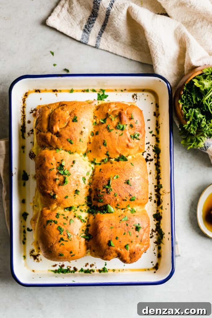 Ham and Swiss Sliders with Honey-Mustard Glaze 9 Six Ham and Cheese Sandwiches Topped with Butter and Parsley