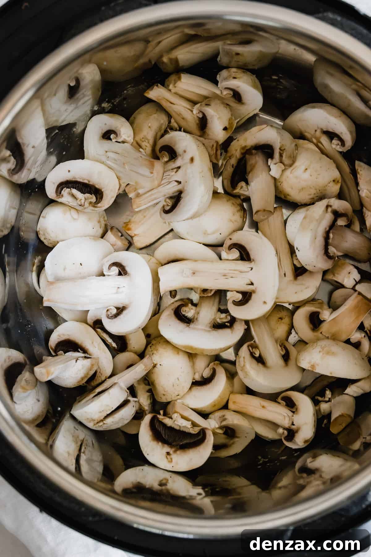 An Instant Pot Bowl Filled with Sliced Mushrooms