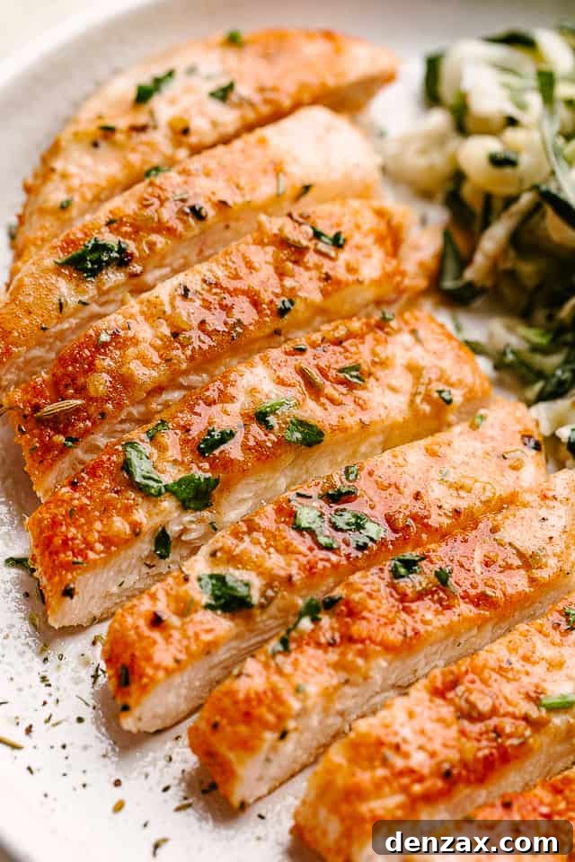 Sliced chicken breast on a white plate.