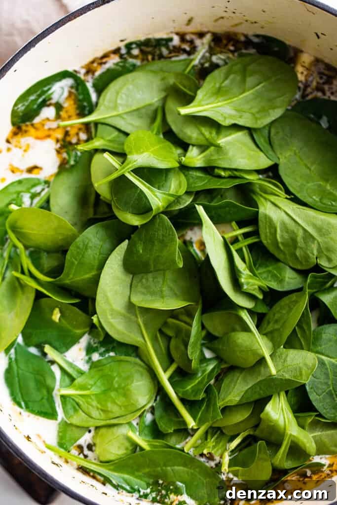 cooking baby spinach leaves in a soup