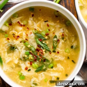 Classic Chinese Egg Drop Soup Recipe: Silky, Simple & Quick 2 overhead shot of a bowl with eggdrop soup garnished with green onions and red pepper flakes